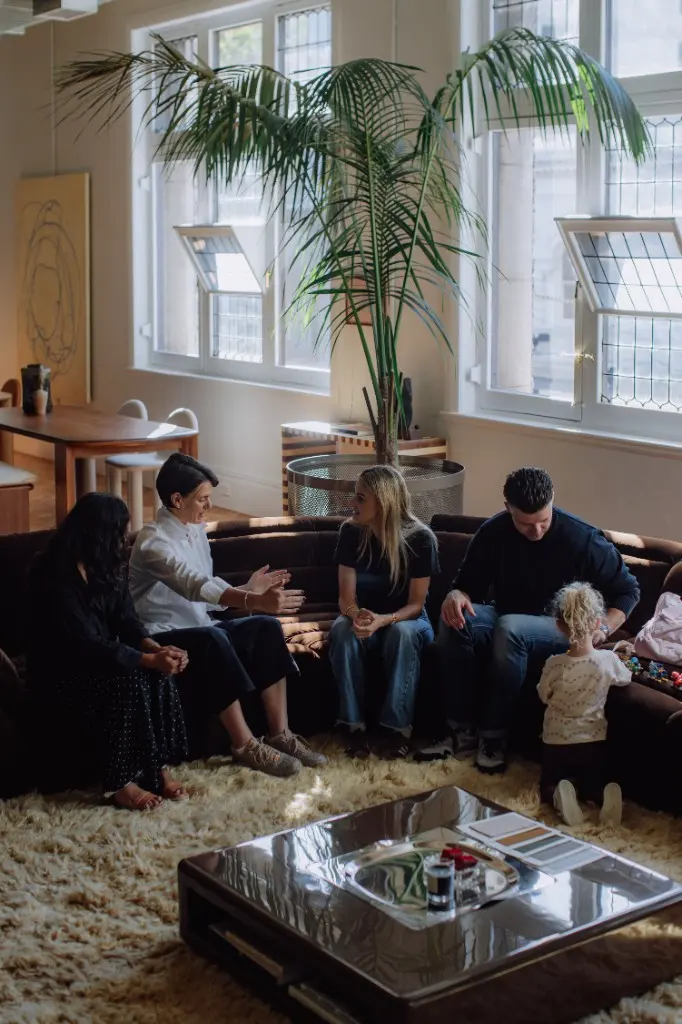 A family talking on a couch — the kind of conversation Tribu makes possible.